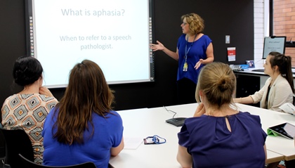 speech pathologist providing training for other professionals